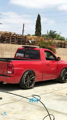 a red pick up truck parked in front of a building