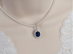 Blue Sapphire Necklace, Bridal Necklace, Bridal Pearl and Blue Sapphire Oval Drop  Necklace, Something Blue Necklace, Wedding Bridal Jewelry Materials: - 10x14mm Blue Sapphire cubic zirconia teardrop pendant - white Swarovski pearls - Rhodium Plated over brass clasp The necklace comes with a 1 1/2 inch rhodium plated over brass extension chain. The listing is for one necklace.  ❤❤ ❤BRIDAL and BULK ORDERS DISCOUNT ❤ ❤❤  5% Discount : 2 items (Use Coupon Code - 5DISCOFF) 10% Discount : 3-5 items (Use Coupon Code - 10DISCOFF) 15% Discount : 6 items and more (Use Coupon Code - 15DISCOFF) Here is a helpful link how to use the coupon code discount: www.etsy.com/help/article/350 The necklace will arrive packaged ready for gift giving in a delicate white jewelry box with a silver ribbon. All metal Pearl Sapphire Necklace, Blue Safire Necklace, Pearl And Sapphire Necklace, Sapphire Necklace Wedding, Blue And Silver Necklace, Blue Gem Necklace, Wedding Choker Necklace, Crystal Wedding Necklace, Rose Gold Bridal Jewelry