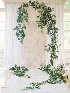 an indoor ceremony with greenery and candles