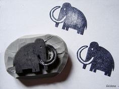 an elephant stamp is placed on top of a piece of paper with scissors in it