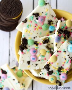 an assortment of cookies and desserts on a plate with white frosting, chocolate chips, and sprinkles