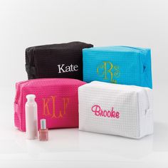 three personalized makeup bags with the word monogrammed on them, one in pink, one in blue and one in white