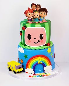 a birthday cake decorated with cartoon characters on top