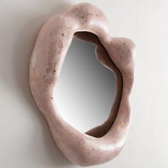 a mirror that is on the wall next to a doughnut shaped like a mouth