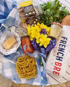 a bunch of food that is on top of a table with some flowers in it