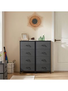 a room with a dresser and pictures on the wall