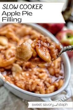 a spoon full of food with apples in the background