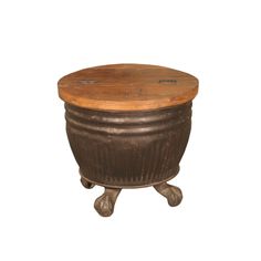 an old wooden pot sitting on top of a metal stand