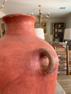 a large red vase sitting on top of a table