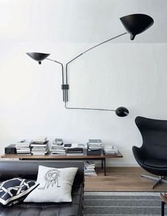 a living room with black furniture and white walls