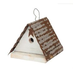 a bird house with a brown and white roof