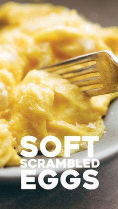 a white plate topped with scrambled eggs and a fork next to the words soft scrambled eggs