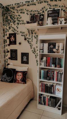 a bed sitting next to a book shelf with books on it and ivy growing up the wall