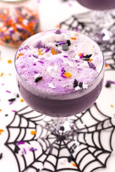 a purple drink with sprinkles on it