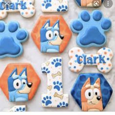 decorated cookies with cartoon characters on them and the number one for each dog's name