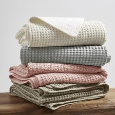 folded blankets stacked on top of each other