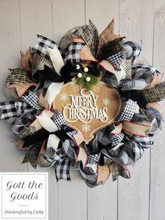 a christmas wreath with the words merry christmas on it