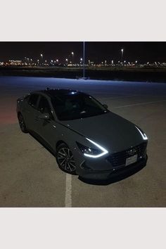 a car parked in a parking lot at night