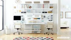 a home office with white walls and shelves filled with books, papers, and computer equipment