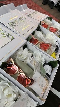 two open boxes filled with wedding cards and sunglasses