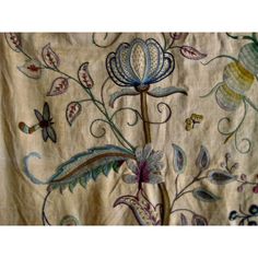 an embroidered fabric with flowers and butterflies on it