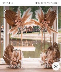 the wedding arch is decorated with flowers and feathers