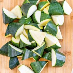 sliced up zucchini sitting on top of a wooden cutting board