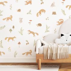 a child's bedroom with wallpaper featuring woodland animals