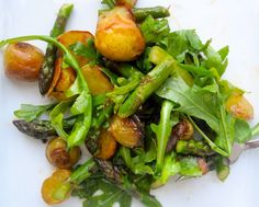 a white plate topped with green vegetables and potatoes