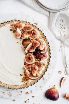 a white plate topped with a pie covered in toppings