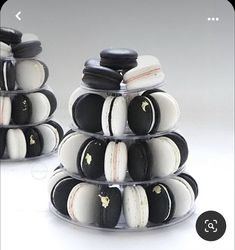 two stacks of black and white macaroons sitting on top of each other