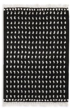 a black and white rug with fringes on it