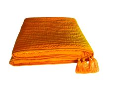 an orange blanket with tassels on it