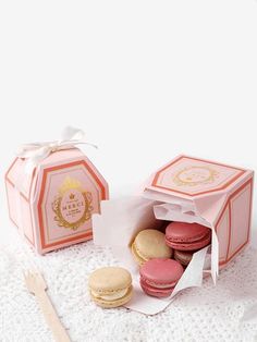 macaroons in a pink box on a white doily