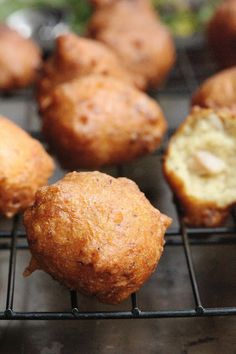 muffins cooling on a wire rack with other pastries in the back ground