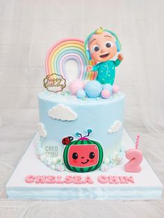 a birthday cake with an image of a child's tv character on top and rainbow in the background