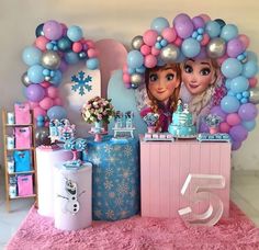 a table with balloons and decorations for a frozen princess birthday party