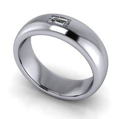 a white gold wedding ring with an emerald stone in the center, on a white background