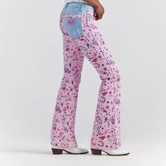 The Wrangler X Barbie Retro High Rise Trouser Jean Takes Pattern Play To A More Adventurous Place. Featuring An All-Over Pattern Of Western Riding Icons, Playful Details, And Plenty Of Pink, This Pair Offers Contrasting Pockets, A 10-Inch High Rise, And A Contoured Waist. It's A Reinterpreted Classic With Limitless Potential, Like The Women Who Wear Them. Fit: Regular Rise: High Front Rise: 10 1/4" Leg: Trouser Leg Opening: 21 3/4" Front Closure: Zipper And Button Western Style Straight Leg Jeans For Spring, Mid-rise Pink Flare Jeans With Five Pockets, Western Style Mid-rise Jeans For Spring, Fitted Casual Jeans For Festivals, Fitted Mid-rise Jeans For Festival, High Rise Cotton Jeans For Rodeo, Trendy Denim Bottoms For Rodeo, Western Style Straight Leg Bottoms With Relaxed Fit, Western Style Relaxed Fit Straight Leg Bottoms