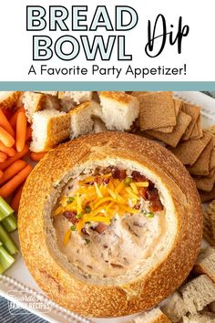 bread bowl dip with carrots, celery and crackers on the side