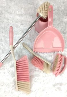 pink bathroom accessories on white fur with brush