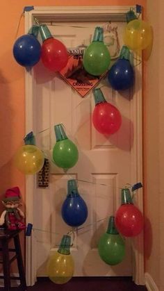 balloons are hanging from the ceiling in front of a door