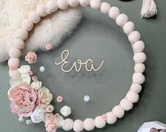 a necklace with the word love spelled in cursive letters surrounded by flowers and other accessories