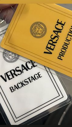 two yellow and black versa cards sitting next to each other on top of a table