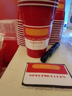 red cups are lined up on a table