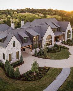 an aerial view of a large house with lots of windows and landscaping on the front lawn