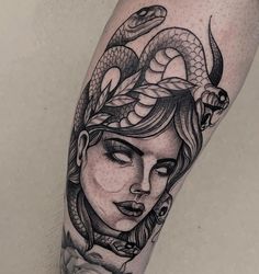 a woman with a snake on her head is shown in black and white tattoo art