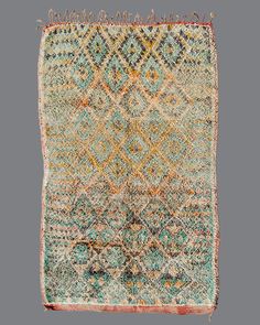 an old rug with many different colors and patterns