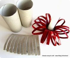 two vases with red ribbons on them next to a pair of white candlesticks