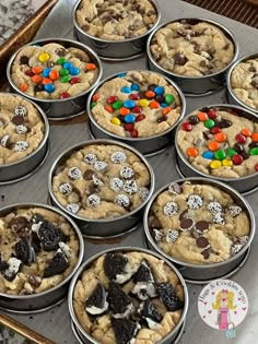 there are many cookies in the pans with m & m on top, and one is chocolate chip